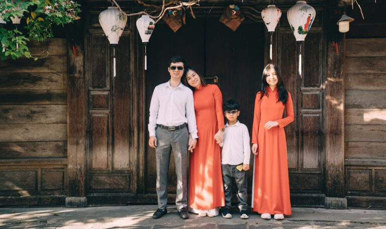 a group of people posing for a photo in front of a wood door